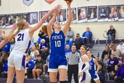 Abbie Cone shoots under the hoop in the district finals game vs. Milford.