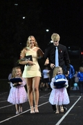 Walking down the track at the coronation, Lillian King, Jada Brummels, Aiden Pospisil, and Lauren King, bring the crowns to the candidates.